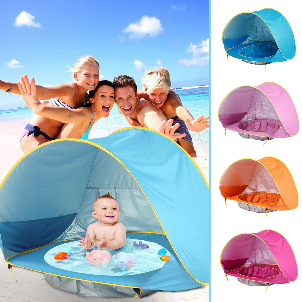 Family enjoying a Stress-Free Beach Day at the beach with a baby in a colorful tent, surrounded by additional tents in different colors.