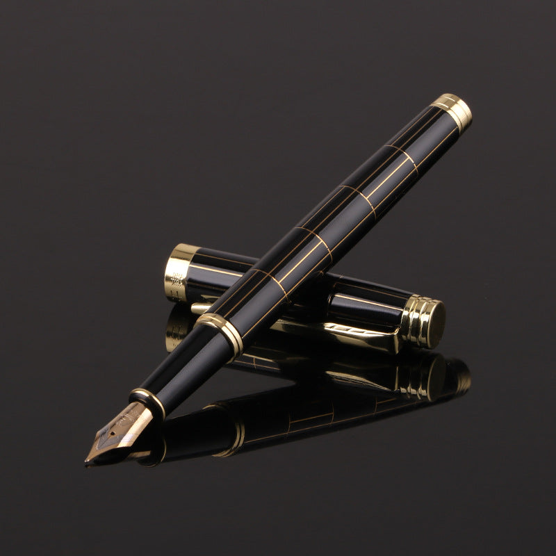 Black and gold fountain pen on a black background.