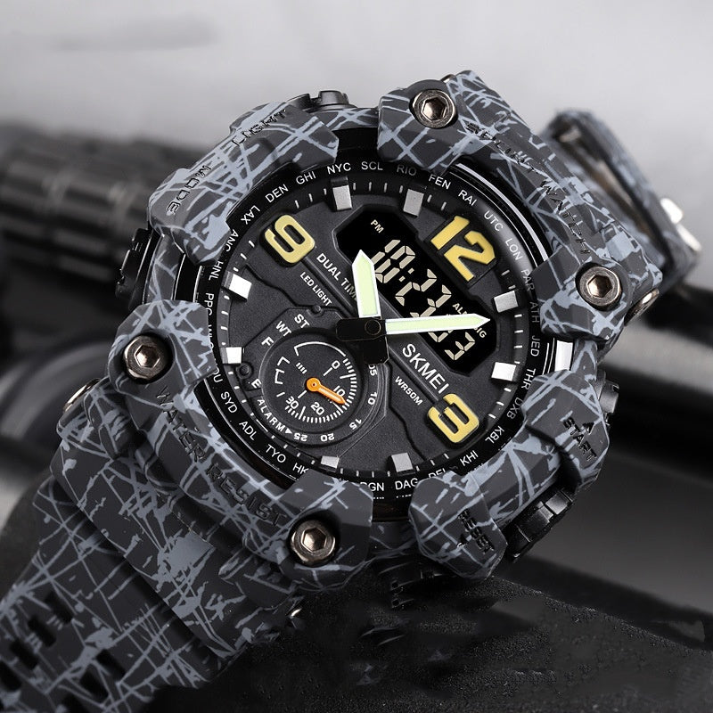 Black and gray camouflage watch with digital and analog display on a dark background.