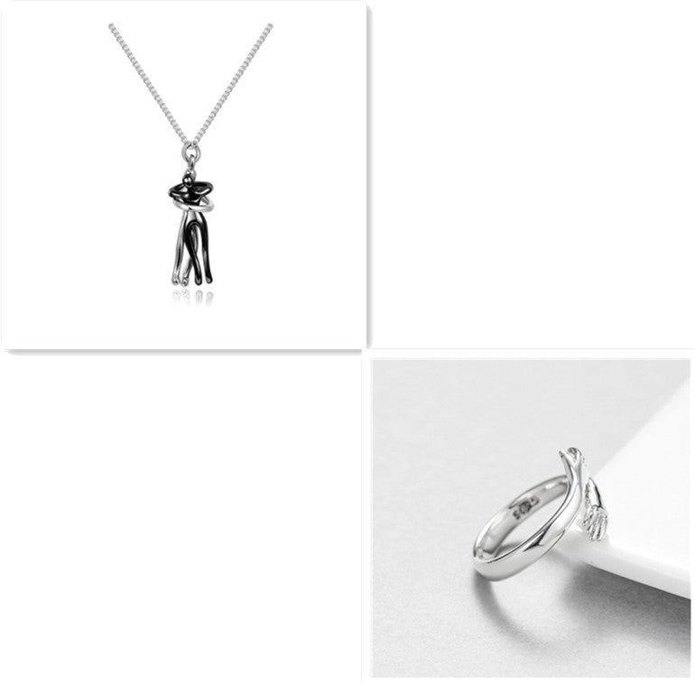 Silver necklace with a black pendant and silver ring on a white background.