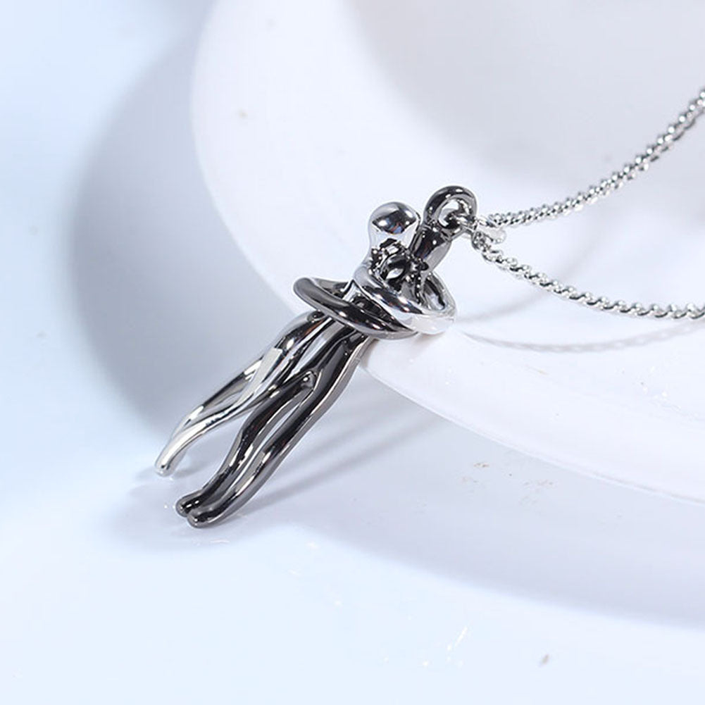 Silver pendant of a person on a white background.