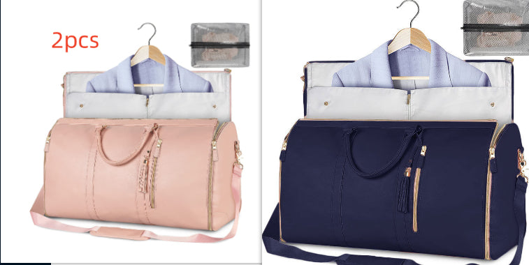 Two travel bags, one pink and one blue, with hangers and shirts inside on a white background.