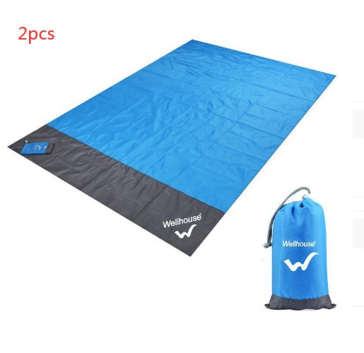 Blue and gray camping mat with carrying bag on a white background.