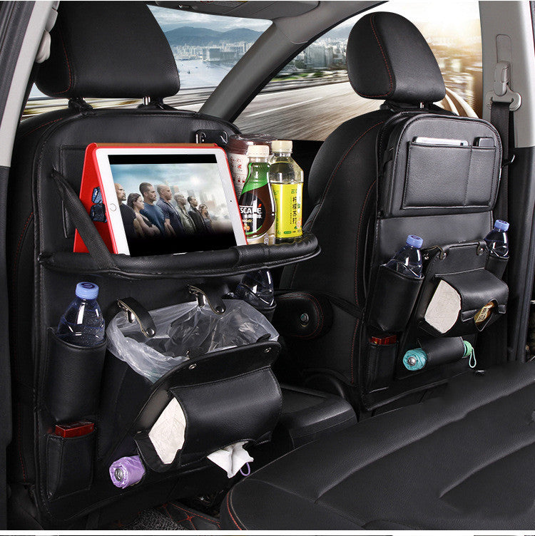 Car back seat with organizer tray, tablet, drinks, and snacks.