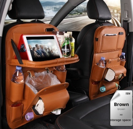 Car back seat organizer with multiple pockets and a tablet stand, filled with items.