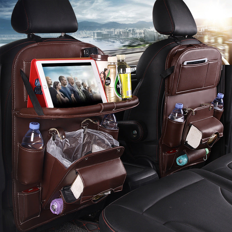 Car back seat organizer with multiple pockets and a tablet holder, with a cityscape in the background.