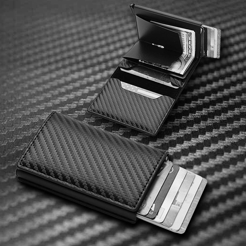 Carbon fiber texture wallet with card slots on a textured surface.