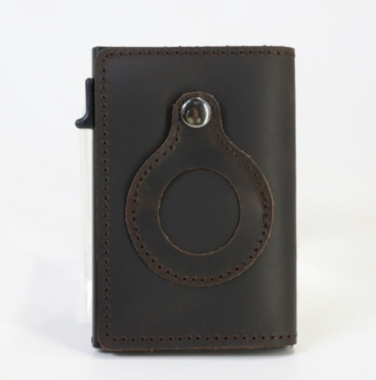 Dark leather cardholder with a circular design on white background.
