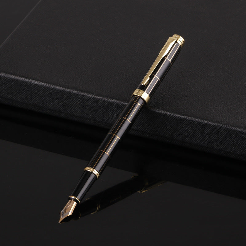 Fountain pen with gold accents on a black background.
