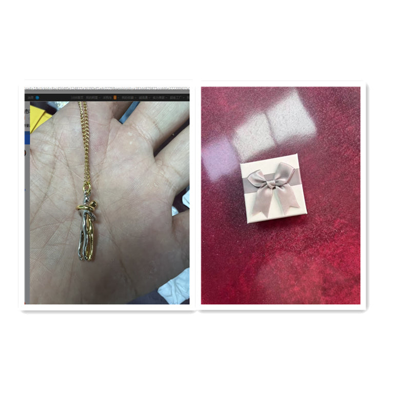 Gold necklace on a hand and a small box with a bow on a red surface.