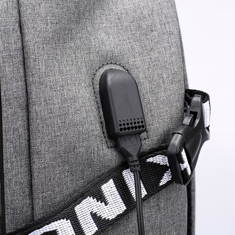Close-up view showing the USB port on a gray backpack.