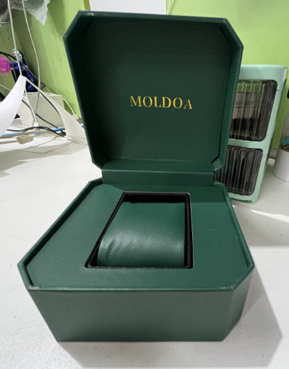Green watch box with «MOLDOA» branding on white surface.