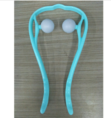 Turquoise handheld massager with two white balls on a wooden surface.