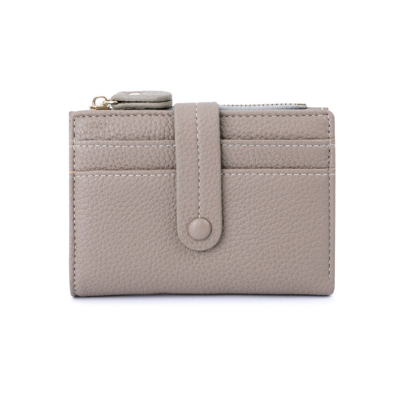 Light gray wallet with a strap on a white background.