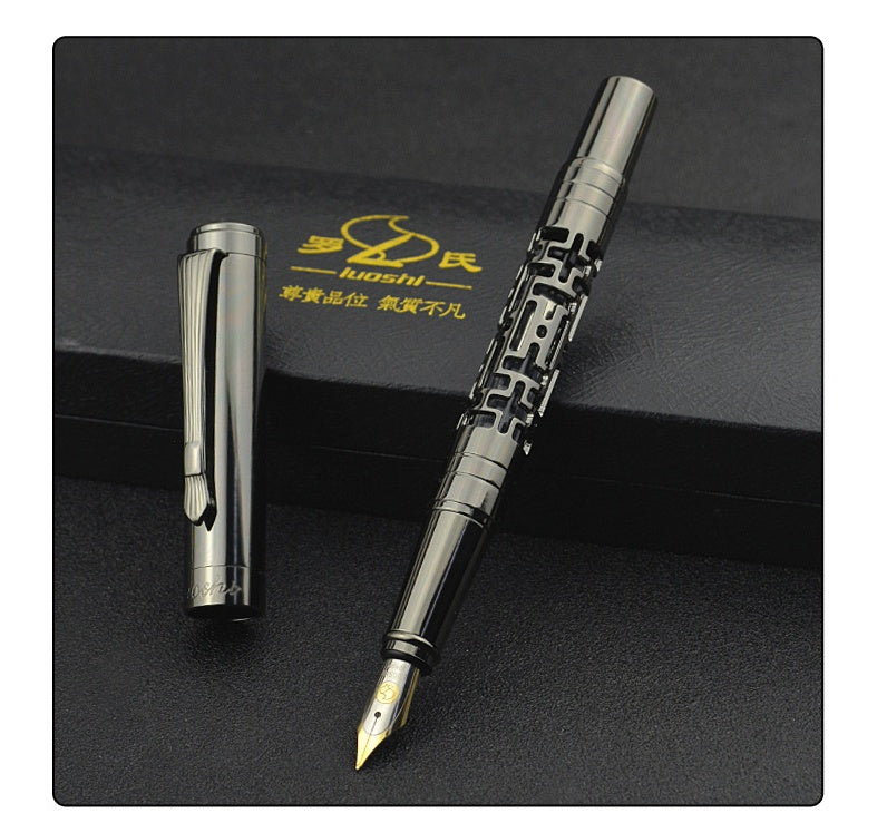 Metallic fountain pen on a black surface with a brand logo in the background.