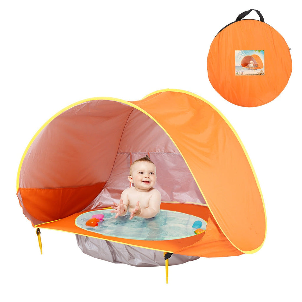 Orange baby play tent with a pool and baby inside, next to a carrying bag.