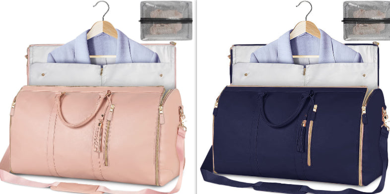 Pink and navy travel bags with hangers and clothes on a white background.