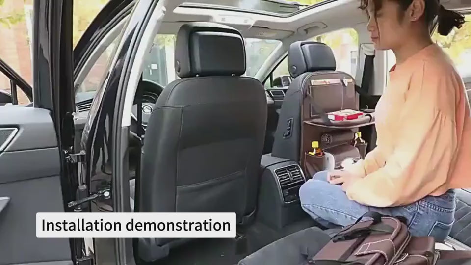 Woman demonstrating installation and use of a car backseat organizer on the rear seat, showing step-by-step installation and real-life loading of the organizer with everyday items during an in-car demonstration.