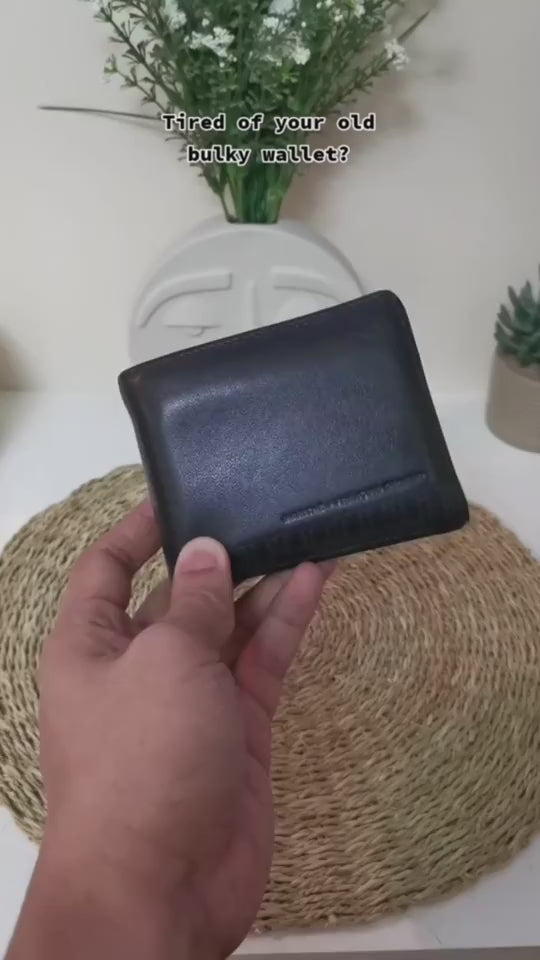 Handheld video showcasing minimalist leather cardholders in black color.