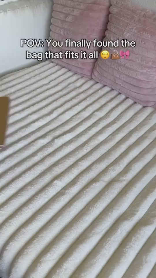 Woman unpacking and packing meals, drinks, snacks, notebooks, pens, cosmetic pouches, wallet and small accessories into a black large capacity foldable waterproof travel duffle bag, closing it and walking away.