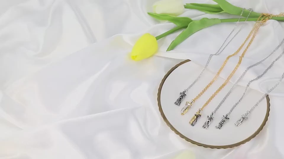 Six hug pendant necklaces displayed on a table, followed by close-up views of each necklace individually on the surface and held in a woman’s hand, rotating to show details and craftsmanship of the unisex lovers hug necklace designs.