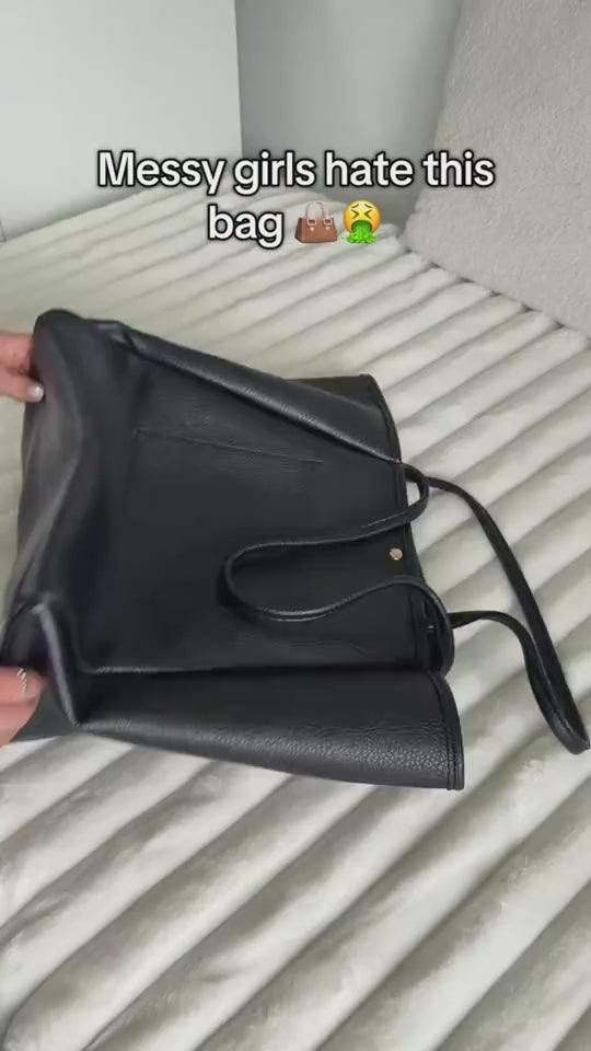 Woman emptying items from an old bag onto a bed and packing snacks, food, notebooks, pens, cosmetic pouch, slippers, headphones, charger, toothbrush, and small accessories into a black large capacity foldable waterproof travel duffle bag, then closing it and leaving.