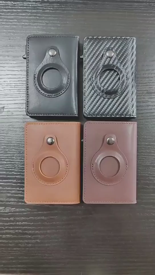 Video showing four empty leather cardholders in different colors on a table, with one hand demonstrating each one in turn.