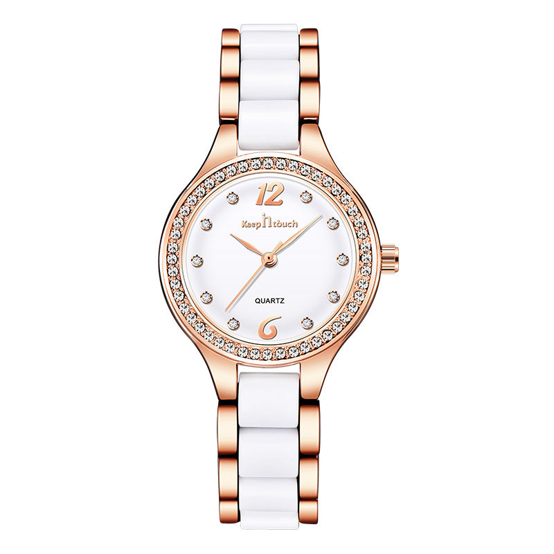 Rose gold and white dial women´s watch with diamond-like accents on white background.