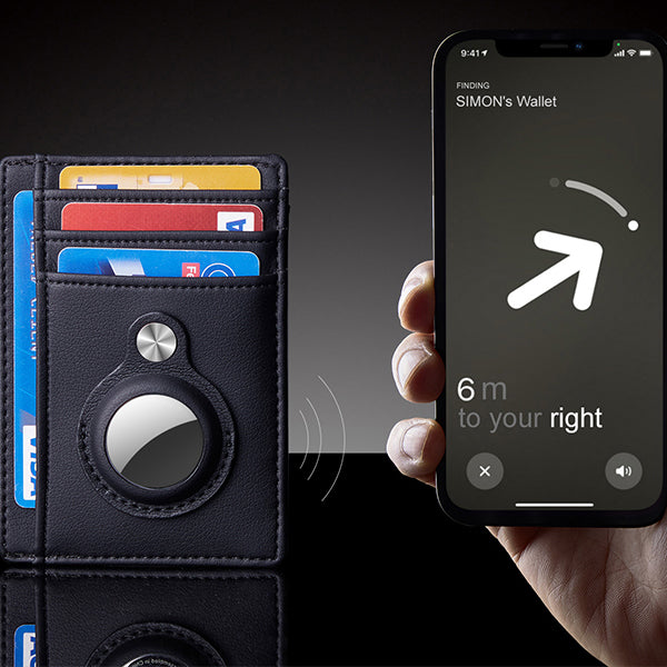 Smart wallet with cards and a phone showing navigation app on dark background.