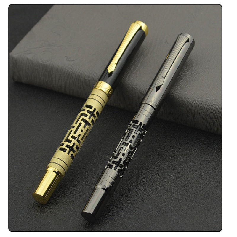 Two ornate pens, one gold and one black on a dark surface.