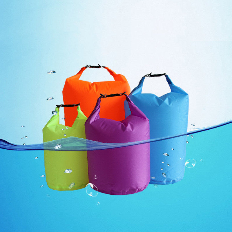 Four colorful waterproof bags (orange, blue, green, purple) floating on water with a blue gradient background.
