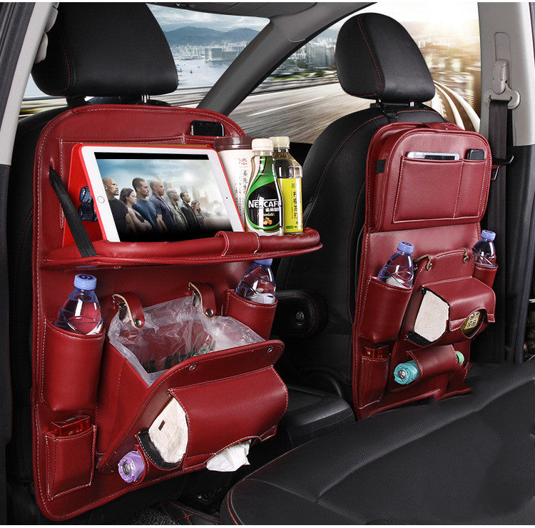 Wine red car seat organizer with multiple pockets and a tablet holder, placed inside a vehicle.